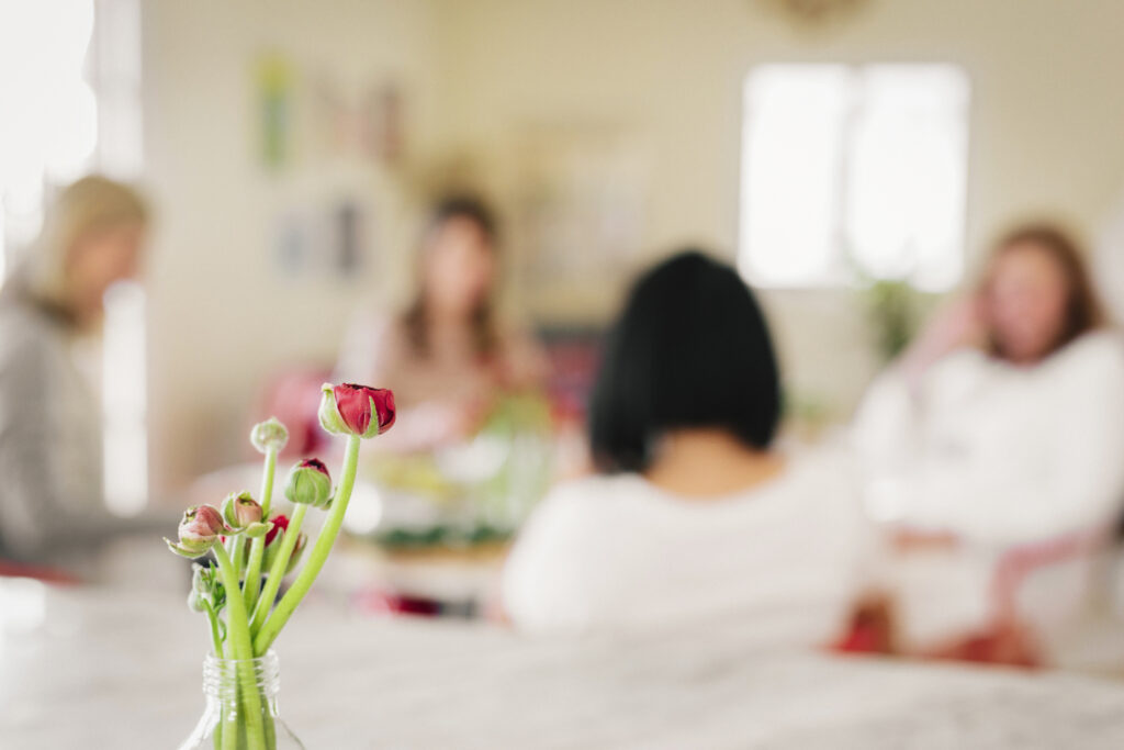 A group of women together around a table.